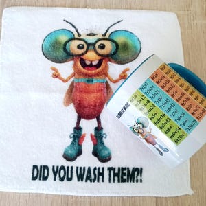 May include: A white hand towel and a ceramic mug with a cartoon insect design. The towel has the text "DID YOU WASH THEM?!" The mug features multiplication tables and a matching insect illustration.