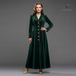 May include: A long, emerald green velvet coat with a tailored fit. The coat features a notched collar, gold trim, and decorative buttons down the front. The sleeves are long, and the coat extends to the ankles. The coat is a classic, elegant design.