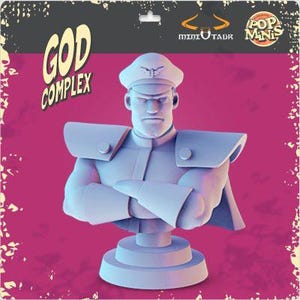 May include: A light blue bust of a stern-faced character with a military-style hat and uniform. The bust is mounted on a circular base. The packaging includes the text "GOD COMPLEX" and "POP MINIS".