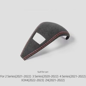 May include: A dark grey car interior trim piece with red stitching. The trim has a rectangular cutout and is designed for specific car models, including the 2, 3, and 4 Series, X3X4, and Z4 models from 2021-2023.