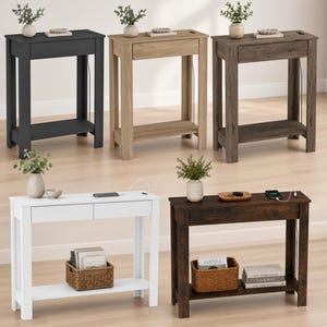 May include: Five rectangular console tables in black, light oak, grey wood, white, and dark brown finishes. Each table features a flat top surface, a single or double drawer, and a lower shelf. Some tables include integrated charging ports.