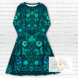 May include: A teal blue long-sleeved dress with a repeating pattern of green butterflies, flowers, and leaves. The dress has a fitted bodice and a flared skirt.