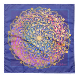 May include: A square blue fabric with a large, intricate gold mandala design. The mandala has a circular pattern with swirls and dots in shades of pink, blue, and yellow. The fabric has a subtle sheen and a soft texture.