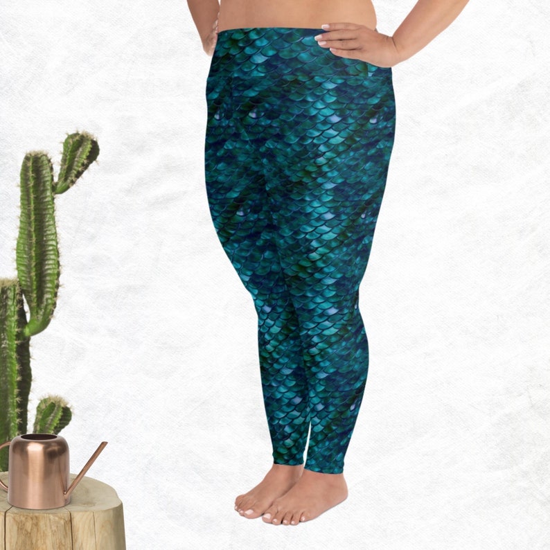 May include: Teal blue leggings with a mermaid scale pattern.