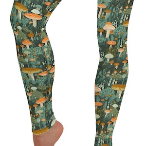 May include: A pair of leggings with a mushroom print. The leggings are green with orange and white mushrooms.