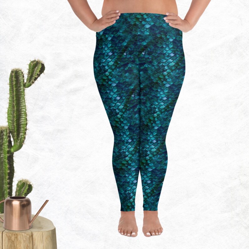 May include: Teal blue leggings with a mermaid scale pattern.