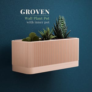 May include: A rectangular, light peach-colored wall plant pot with vertical ribbed detailing. The pot is filled with various succulents. The text "GROVEN Wall Plant Pot with inner pot" is displayed above the pot against a dark teal background.