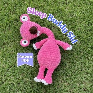 May include: A pink crocheted Sleep Buddy Sid plush toy with a long neck, large eyes, and white accents on its feet and hands. The text "Sleep Buddy Sid" is written in blue and white cursive. The text "Pattern PDF" is in a blue and white banner.
