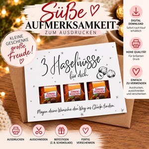 Könnte beinhalten: Eine weiße rechteckige Karte mit dem deutschen Text 3 Haselnüsse für dich und Mögen deine Wünsche den Weg ins Glück finden, mit drei Ausstanzungen für Ferrero Küsschen Schokolade, verziert mit kleinen grauen Sternen und Haselnuss-Illustrationen.