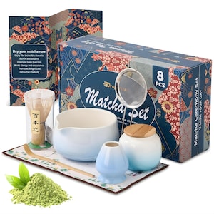 May include: A matcha ceremony set with a blue and white gradient ceramic bowl, a bamboo whisk, a scoop, a sifter, and a small jar with a wooden lid. The set includes a box with floral patterns and the text "Matcha Ceremony Set".