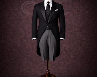 May include: A formal black tuxedo with a white dress shirt, black tie, and gray striped trousers. The tuxedo is displayed on a wooden mannequin with the brand name "VALENFOLD" visible in the upper right corner.