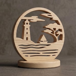 May include: A circular light-colored wooden carving featuring a cutout scene of a lighthouse, a sailboat on wavy water, and a tree. The entire piece is mounted on a solid, flat, circular wooden base, showcasing natural wood grain textures.