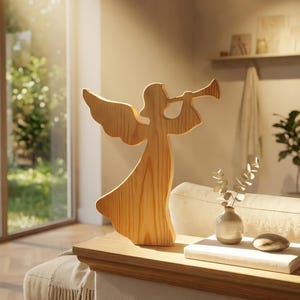 May include: A light brown wooden cutout figurine of an angel with wings, depicted in a standing position while holding a trumpet to its mouth. The figure features a smooth, natural wood grain texture and a simple, stylized silhouette design.