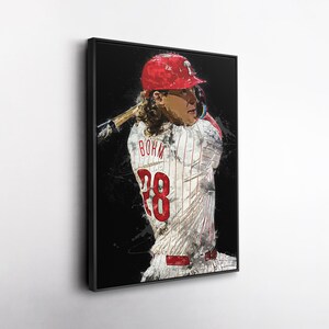 May include: A framed art print of a baseball player in a Phillies uniform, with the number 28 visible. The player is wearing a red helmet and holding a bat. The artwork has a painterly style with a black background.