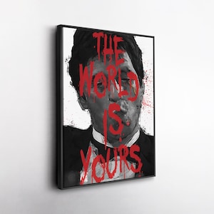 May include: Black and white framed art print featuring a portrait of a man smoking a cigar. The words "THE WORLD IS YOURS" are written in red across the image. The artwork has a painterly style with red paint splatters.