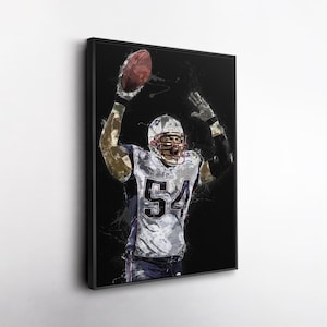 May include: Framed artwork of an American football player in a white and blue uniform, number 54, holding a football. The artwork has a black background with white paint splatter effects. The player is wearing a helmet with a red face mask.