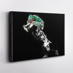 May include: Framed artwork depicting a football player in a green uniform leaping over another player in a black and white uniform. The image has a painterly effect with white brushstrokes against a black background.