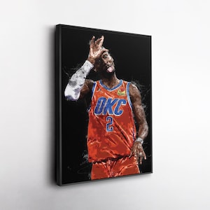May include: Framed art print of a basketball player in an orange jersey with the text "OKC" and the number "2". The player is making a gesture with his hand and sticking out his tongue. The artwork has a black background.