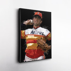 May include: A framed artwork depicts a baseball pitcher in action, wearing a red and orange Astros uniform. The word "Astros" is across the chest. The artwork has a black background and a black frame.