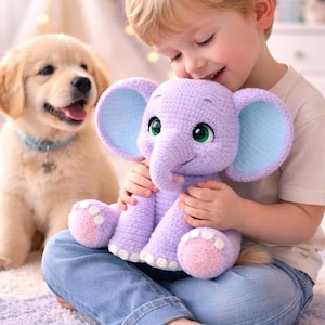 May include: A crocheted lavender elephant plush toy with light blue ears and green eyes is held by a child. A golden retriever puppy with a blue collar sits nearby. The scene is set indoors with soft lighting.