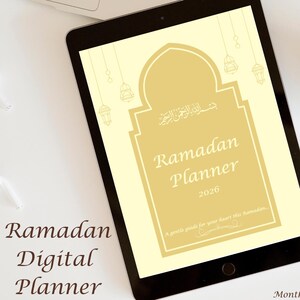May include: A digital Ramadan planner displayed on a black iPad. The planner has a cream-colored background with gold accents and text that reads "Ramadan Planner 2026." A cup of coffee and a stylus are also visible.