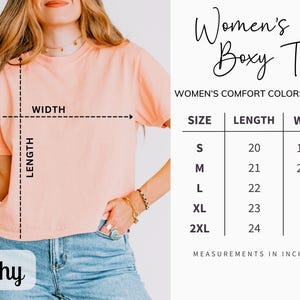 May include: A peach-coloured boxy tee shirt with the word "Peachy" at the bottom. The shirt's measurements are displayed in inches. The text "Women's Boxy Tee" is at the top of the image.