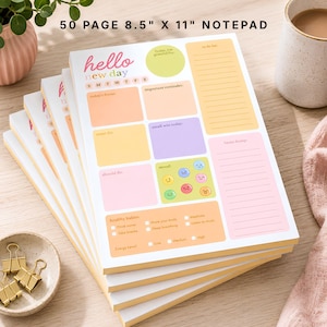 May include: A 50 page 8.5 inch by 11 inch notepad with a colorful daily planner layout. The page features sections for a to-do list, healthy habits, mood tracking with emojis, and daily focus areas, all printed in pastel pink, yellow, orange, and purple.
