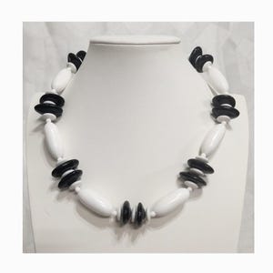 May include: A set of three ceramic mugs with a speckled, matte finish. The mugs are in shades of cream, light gray, and dark gray. Each mug has a simple, minimalist design, perfect for coffee or tea.