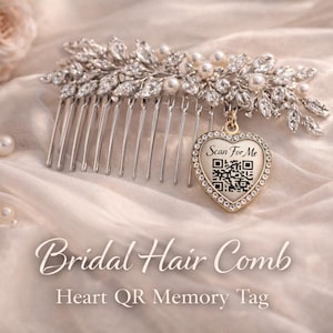 May include: A silver bridal hair comb with a leaf and pearl design, featuring a heart-shaped QR code tag that says "Scan For Me". The comb is set against a soft, cream-colored fabric with scattered pearls and a bouquet of roses.
