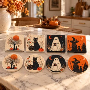May include: A set of eight Halloween-themed coasters in square and round shapes. The designs feature black cats, ghosts, witches, pumpkins, and trees in orange, black, and cream colors. Each coaster displays detailed seasonal illustrations.