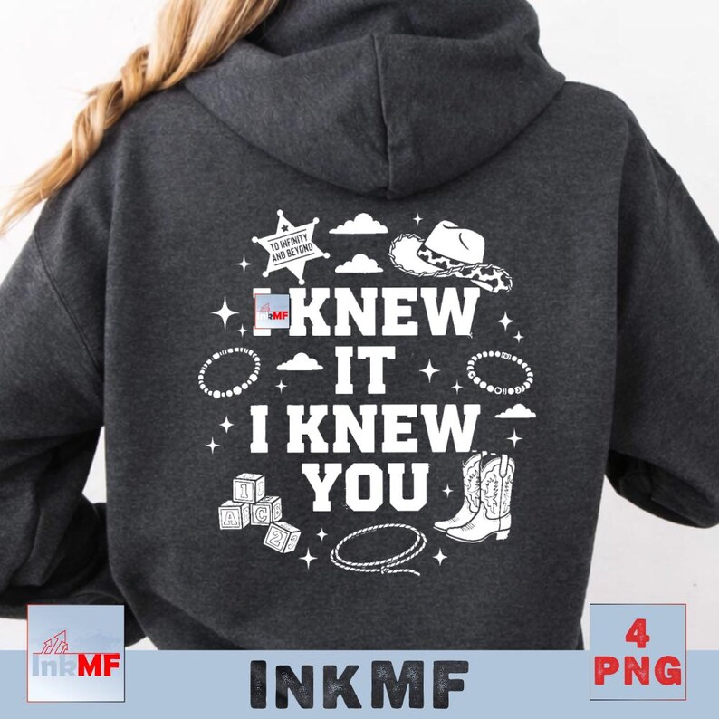 May include: A dark charcoal gray hooded sweatshirt featuring a white graphic on the back. The text reads I KNEW IT I KNEW YOU, surrounded by illustrations of a sheriff star with the text TO INFINITY AND BEYOND, a cowboy hat, blocks, a lasso, and stars.