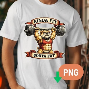 May include: White t-shirt featuring a cartoon bulldog lifting a barbell. The bulldog is wearing a red tank top and has a muscular physique. The text "KINDA FIT" and "SORTA FAT" are displayed on banners above and below the bulldog.
