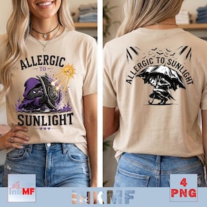 May include: A beige short-sleeve t-shirt featuring a graphic print on the front and back. The front shows a hooded character holding a shield against a sun with the text ALLERGIC TO SUNLIGHT. The back shows a vampire under an umbrella with the same text.