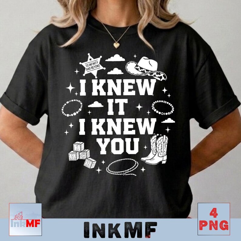 May include: A black t-shirt featuring white graphic text that reads I KNEW IT I KNEW YOU. The design includes a sheriff star with the text TO INFINITY AND BEYOND, a cowboy hat, a lasso, alphabet blocks, and cowboy boots surrounded by stars and clouds.