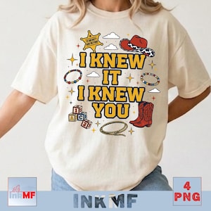 May include: A cream-colored t-shirt featuring a graphic print with the text I KNEW IT I KNEW YOU in yellow. The design includes a sheriff star, a red cowboy hat, alphabet blocks, a lasso, beaded bracelets, and small cloud and star icons.