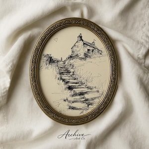 May include: An oval, antique-style framed print featuring a pen and ink sketch of a stone cottage atop a hill. A set of stone steps leads up to the cottage. The frame is gold-colored, and the print has the text "Archive Art Co."