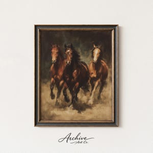 May include: Framed artwork featuring three brown horses galloping across a dusty landscape. The horses are depicted in a vintage style, with a dark background and a black frame. The artwork is signed "Archive Art Co."