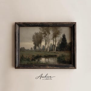 May include: An antique landscape painting in a distressed black wooden frame. The artwork depicts a serene scene with trees, a body of water, and a cloudy sky. The painting has a vintage aesthetic, with the text "Archive Art Co." in the bottom right corner.