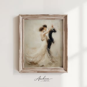 May include: A framed art print depicts a couple dancing, rendered in soft, muted tones. The woman wears a flowing white dress, while the man is in a black suit. The frame is a distressed, light-colored wood. The artwork is signed "Archive Art Co."