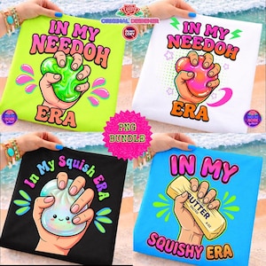 May include: Four colorful t-shirts with playful graphics. Each shirt features a hand squeezing a squishy toy or butter, with text like "In My Needoh Era" and "Squishy Era." The shirts are in various colors, including green, white, black, and blue.