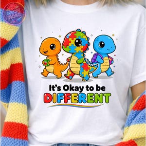 Autismmedvetenhet PNG Det är okej att vara annorlunda dinosaurie barnskjorta färgglad pussel dinosaurieinkludering lärarpresent sublimering PNG