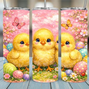 May include: A stainless steel tumbler with a design of a yellow chick, Easter eggs, butterflies, and flowers. The background is a soft pink with a floral pattern, creating a festive and spring-like aesthetic.