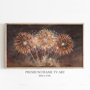 Könnte beinhalten: Gerahmter digitaler Kunstdruck mit einem Feuerwerk. Das Kunstwerk zeigt drei große, gold-orangefarbene Explosionen vor einem dunklen, rauchigen Hintergrund. Der Text "PREMIUM FRAME TV ART" und die Abmessungen sind unten sichtbar.