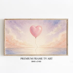 Könnte beinhalten: Aquarellmalerei eines rosa herzförmigen Ballons, der über einer Meereslandschaft mit einem Sonnenuntergangshimmel schwebt. Das Kunstwerk ist gerahmt und enthält den Text "PREMIUM FRAME TV ART" und die Abmessungen 3840 x 2160.