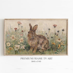 Könnte beinhalten: Eine weiße Keramik-Tasse mit schwarzem Henkel und dem Text "But First, Coffee" in fetter, schwarzer Schrift. Die Tasse steht vor einem verschwommenen Hintergrund, der eine gemütliche Umgebung suggeriert.