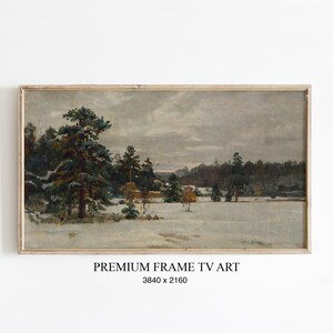 Könnte beinhalten: Gerahmtes Landschaftsgemälde mit einem schneebedeckten Feld und immergrünen Bäumen unter einem bewölkten Himmel. Das Kunstwerk befindet sich in einem rechteckigen Holzrahmen. Der Text "PREMIUM FRAME TV ART" und die Abmessungen stehen unten.