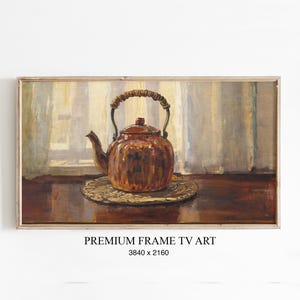 Könnte beinhalten: Gerahmter Kunstdruck eines Stilllebens mit einer kupferfarbenen Teekanne mit geflochtenem Griff, die auf einem runden, strukturierten Untersetzer steht. Der Hintergrund zeigt ein Fenster mit transparenten Vorhängen. Der Text "PREMIUM FRAME TV ART" steht unten.