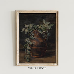 May include: A framed vintage-style print featuring a brown pitcher with a handle, filled with green leafy branches. The artwork has a dark, moody aesthetic with the text "ASTOR PRINTS" at the bottom.