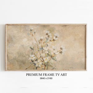 Könnte beinhalten: Rechteckiger gerahmter Kunstdruck mit einem Aquarellgemälde von weißen Blumen und grünen Blättern vor beigem Hintergrund. Der Text "PREMIUM FRAME TV ART" und die Abmessungen 3840 x 2160 stehen unten.