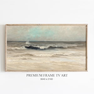Könnte beinhalten: Gerahmtes Landschaftsgemälde des Ozeans. Das Kunstwerk zeigt Wellen, die an einem sandigen Strand unter einem bewölkten Himmel brechen. Das Gemälde hat eine gedämpfte Farbpalette aus Blau-, Grau- und Beigetönen. Der Text "PREMIUM FRAME TV ART" steht unten.